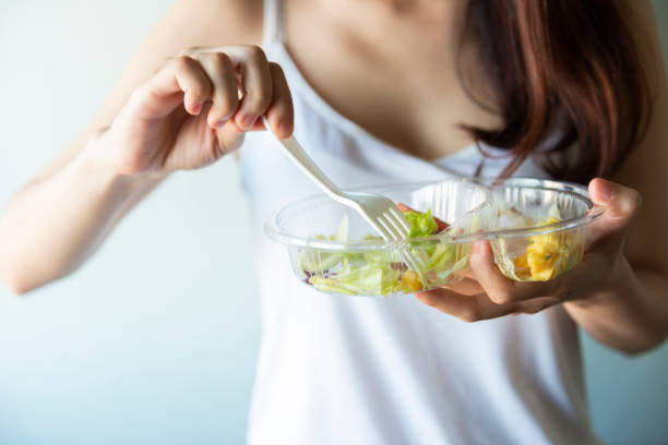 istock Young women eating salad 947710308