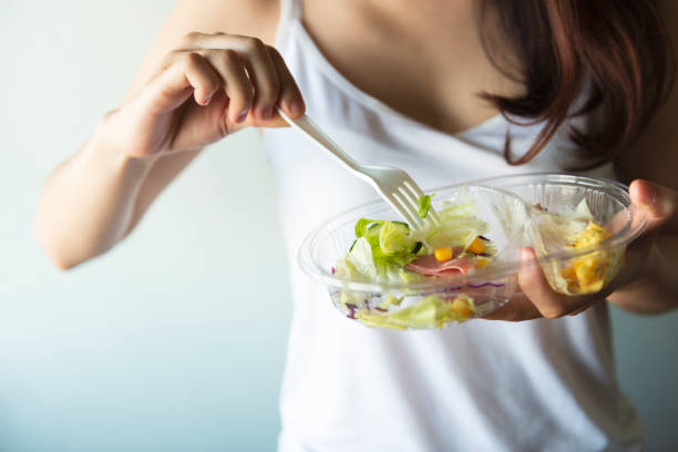 istock Young women eating salad 947710324