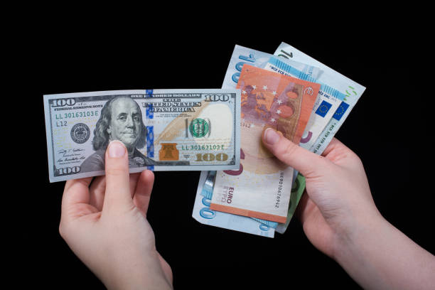 istock Hand holding American dollar  isolated on black background 947710458