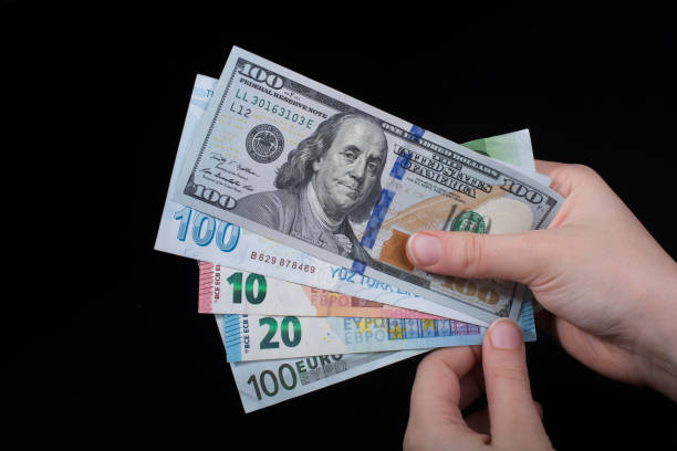 istock Hand holding American dollar  isolated on black background 947710476