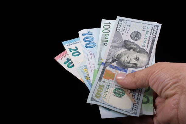 istock Hand holding American dollar  isolated on black background 947710544