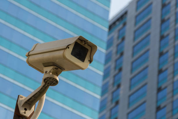 istock Security camera (CCTV) for safety on blue sky and city background 947714312