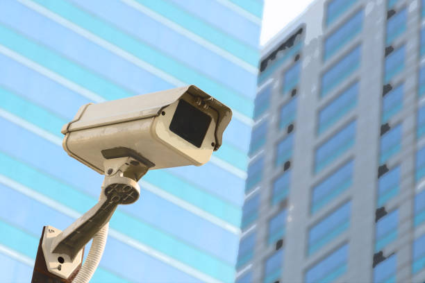 istock Security camera (CCTV) for safety on blue sky and city background 947714346