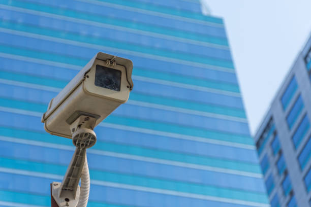 istock Security camera (CCTV) for safety on blue sky and city background 947714354