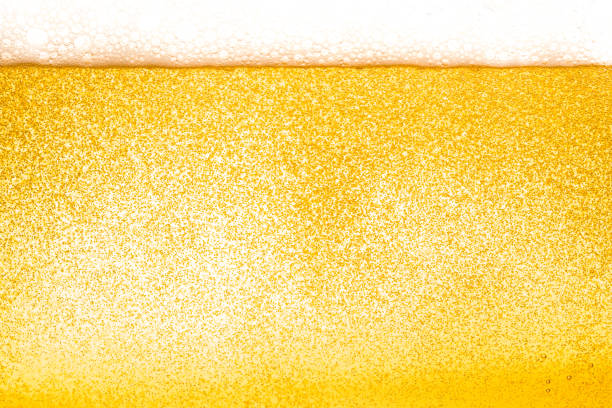 istock Abstract  gold color beer drink background, with white foaming buble texture, alcohol drink, pub and bar background concept 947721178