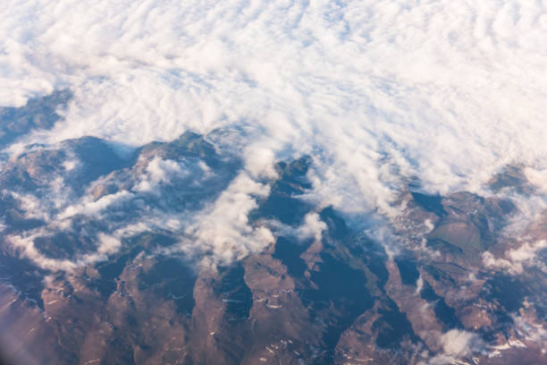 istock Wing of an airplane flying above the clouds with blue sky. 947721568
