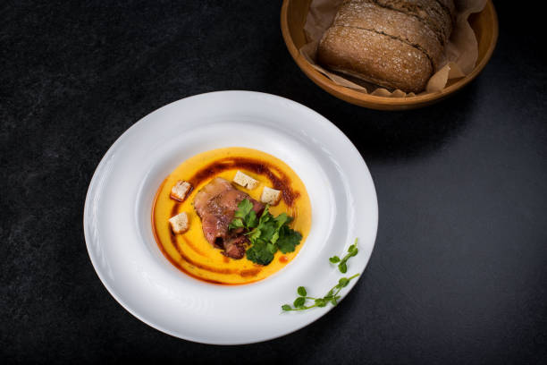 istock An appetizing pumpkin soup is served in a white plate in a restaurant 947721840