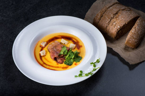 istock An appetizing pumpkin soup is served in a white plate in a restaurant 947721878