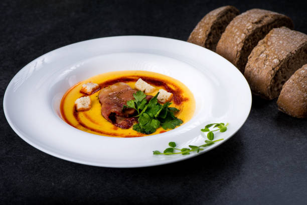 istock An appetizing pumpkin soup is served in a white plate in a restaurant 947721896