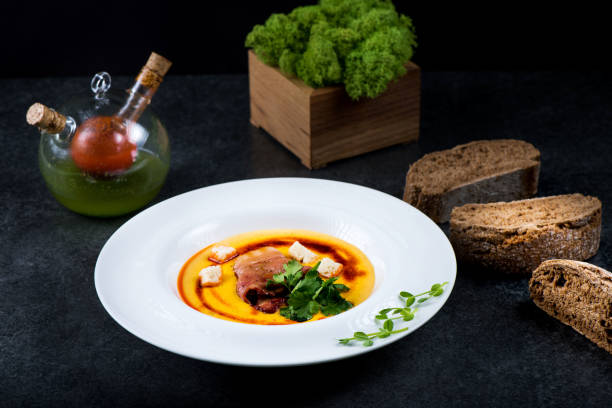 istock An appetizing pumpkin soup is served in a white plate in a restaurant 947722008