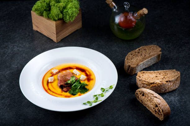istock An appetizing pumpkin soup is served in a white plate in a restaurant 947722042