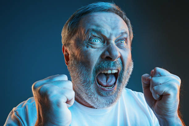 istock The senior emotional angry man screaming on blue studio background 947724376