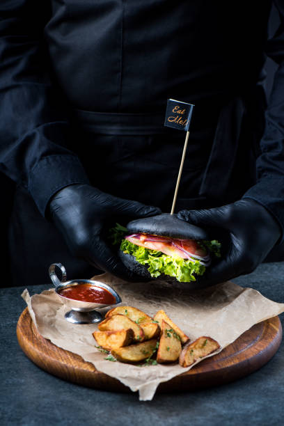 istock Black burger on a wooden plate 947724822
