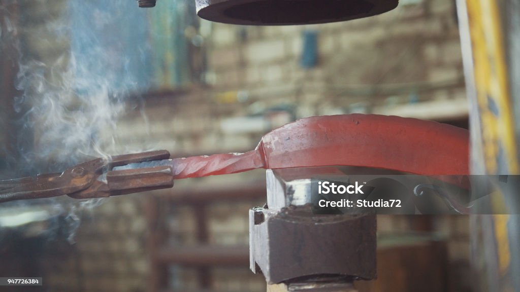 The blacksmith manually forging in the smithy The blacksmith manually forging in the smithy, close up Anvil Stock Photo