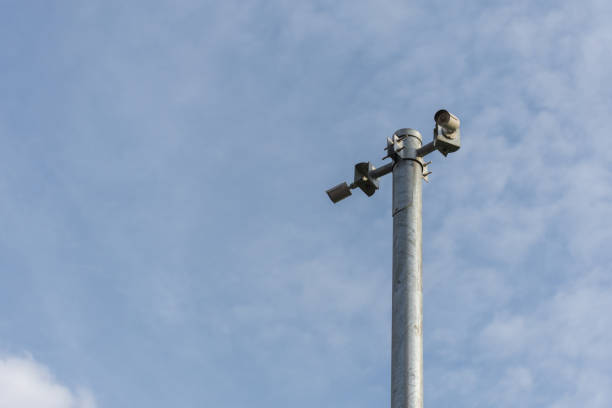 istock Security camera (CCTV) for safety on blue sky and city background 947729172