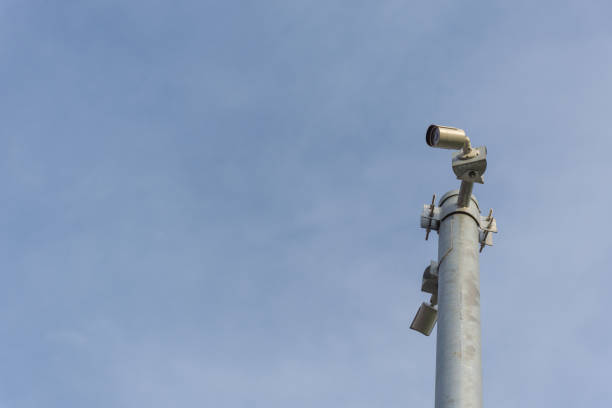 istock Security camera (CCTV) for safety on blue sky and city background 947729206