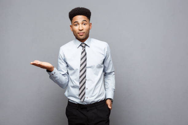 istock Business Concept - Amazed African American holding both hands on side presenting projects over grey background. 947730028