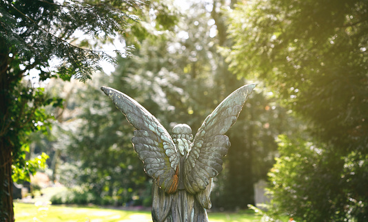 Weathered old copper angel statue at the Melaten Graveyard.