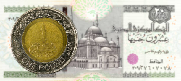 istock 1 egyptian pound coin against 20 egyptian pound bank note full frame obverse 947738762