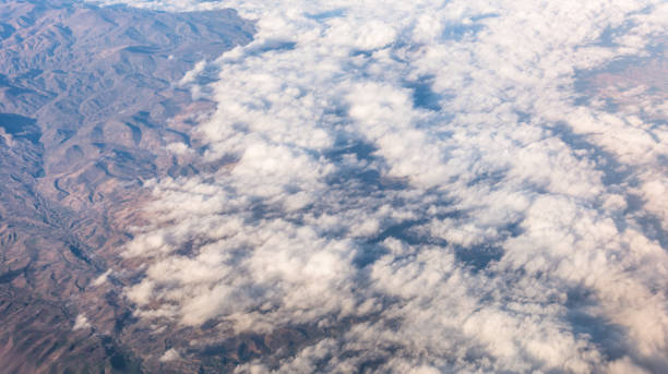 istock Wing of an airplane flying above the clouds with blue sky. 947739176