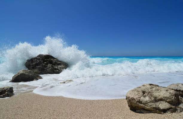 istock White wave splash over dark stone, famous Kathisma beach 947739416