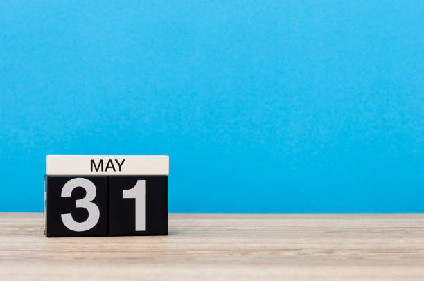 istock May 31st. Day 31 of month, calendar on blue background. Spring time, empty space for text 947748354