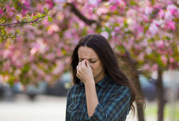 istock Woman having allergy reaction on blooming tree 947749334