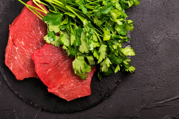 Fresh raw beef tenderloin and marbled steaks with seasoning