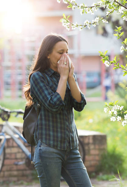 istock Woman having allergy reaction on blooming tree 947751834