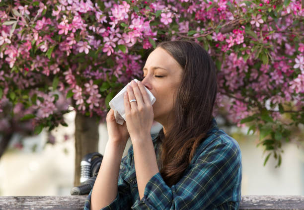 istock Woman having allergy reaction on blooming tree 947751864