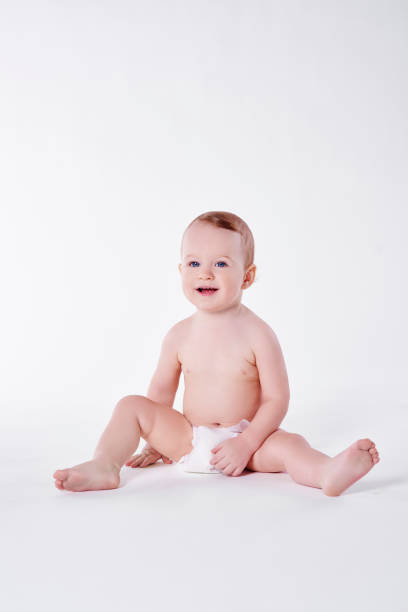 istock Boy in diaper sitting at studio shot 947752454