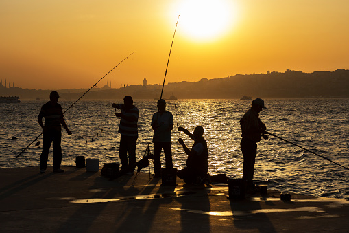 Hobby, a man is fishing with a fishing rod on the seashore