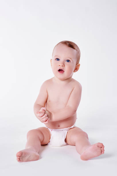 istock Confused baby boy sitting at studio shot 947755886