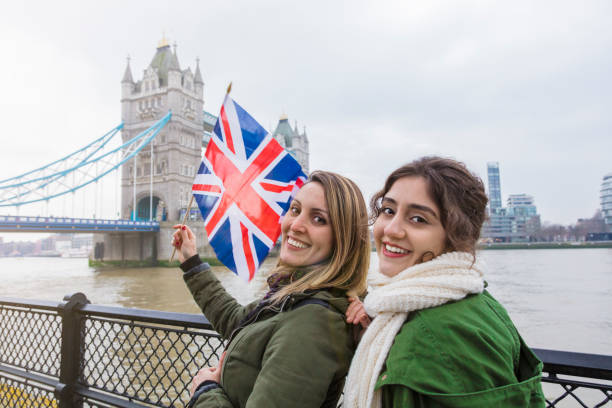 istock Tourist friends holding British flag 947756296