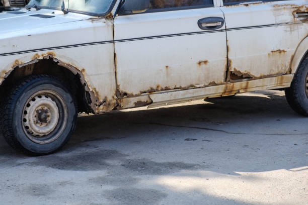istock Old rotten rusty car is abandoned on the road 947756328