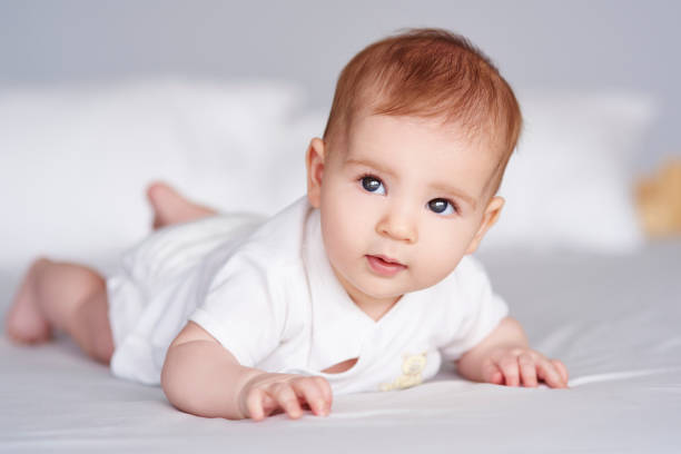 istock Small baby lying on front at bedroom 947757030