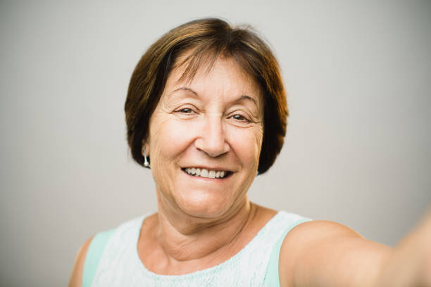 istock Beautiful mature woman taking selfie 947762298