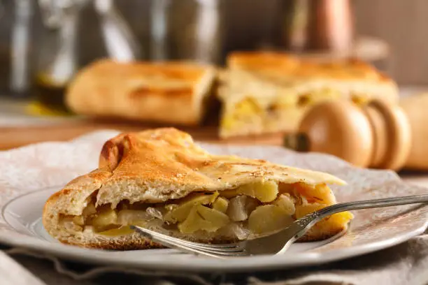 Photo of slices of homemade potato pie on pink plate