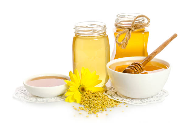 istock beekeeper's still life. Honey, pollen and yellow flower 947768340