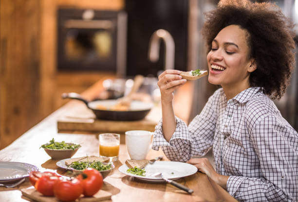 istock Happy black woman enjoying during breakfast time in the kitchen. 947772764