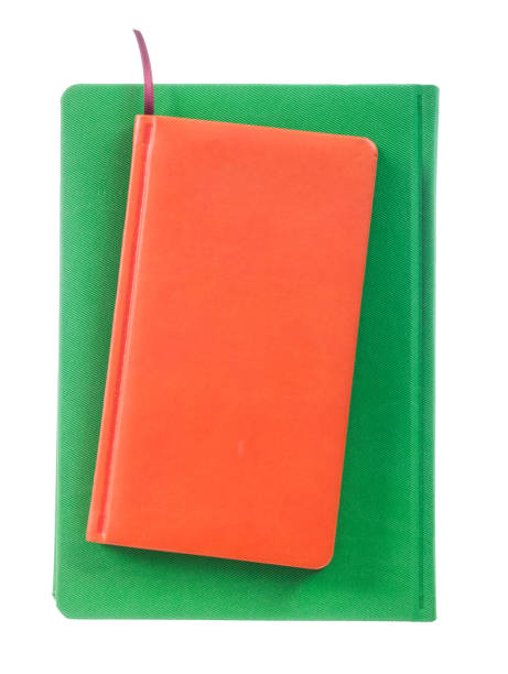 istock Orange and green notepads isolated on white 947773694