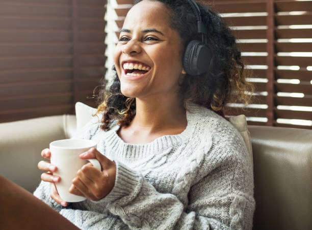 istock Woman enjoying music on her sofa 947777502