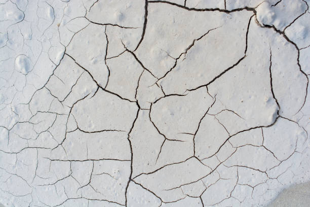 istock Gray color dry cracked muddy earth 947777700