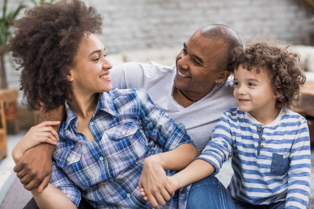istock Young loving African American family communicating at home. 947777724