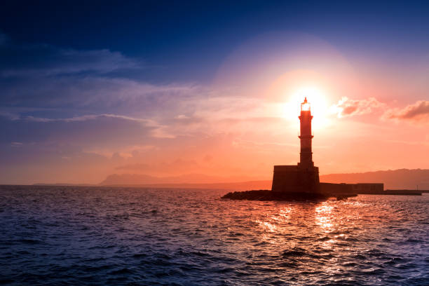 istock A beautiful night sky behind a shining lighthouse. Crete, Greece 947783440