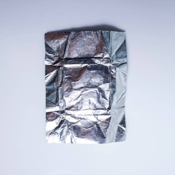 istock Wrinkled aluminium foil Paper isolated on white background 947783646