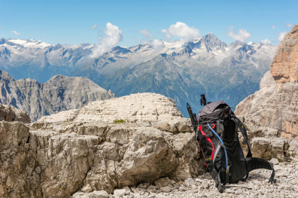 Mountain view with backpack sitting next to rock. stock photo