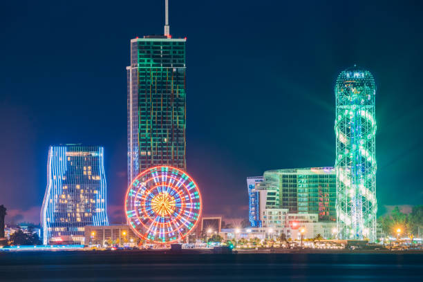 istock Batumi, Adjara, Georgia. Modern Architecture In Seafront Promenade. Miracle Park With Modern Buildings In Night Or Evening Illuminations Lights, Illuminated Resort Town Cityscape 947790774