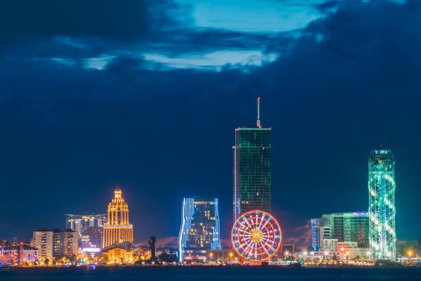 istock Batumi, Adjara, Georgia. Modern Architecture In Seafront Promenade. Miracle Park With Modern Buildings In Night Or Evening Illuminations Lights, Illuminated Resort Town Cityscape 947793398