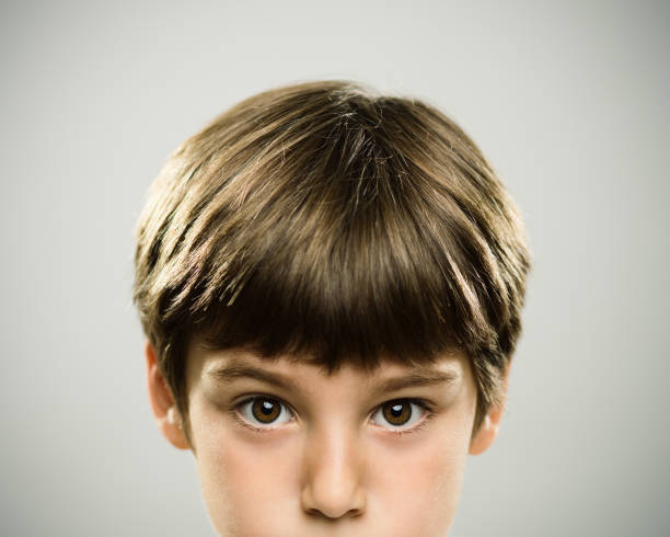 istock Portrait of a caucasian real boy with serious expression. 947797584